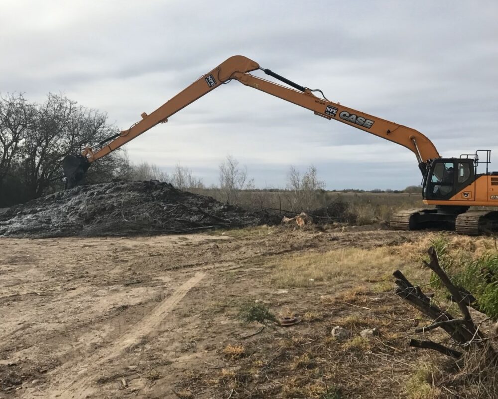 A photo of removed material from the shoreline excavation project. Bullock Construction's cutting edge excavating equipment showcases its ability to handle challenging terrains as part of efficient dredging operations in complex environments.
