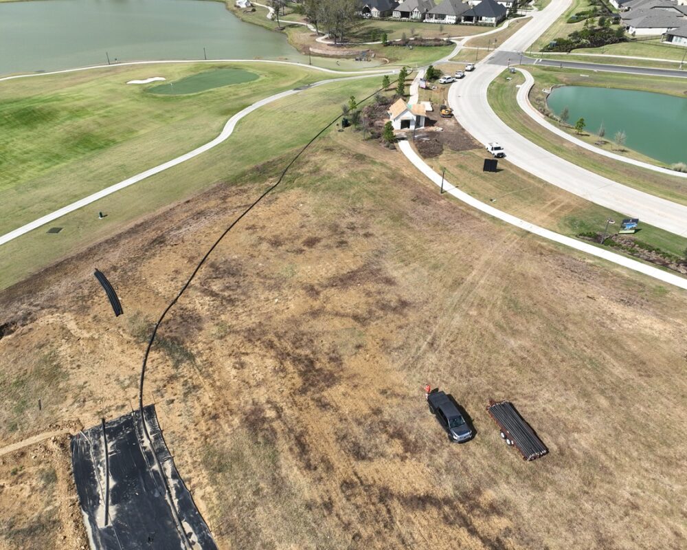 Hydraulic dredge pumping sediment from golf course pond with minimal site disruption.