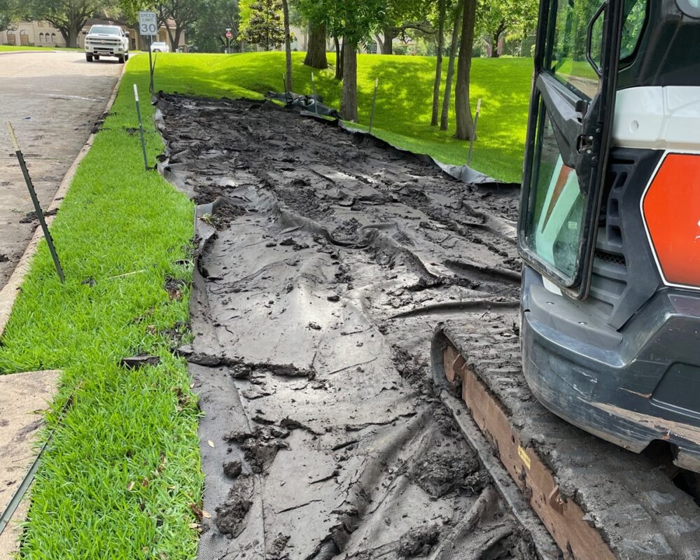 Dewatering bag removal in a residental area after a water retention pond project.