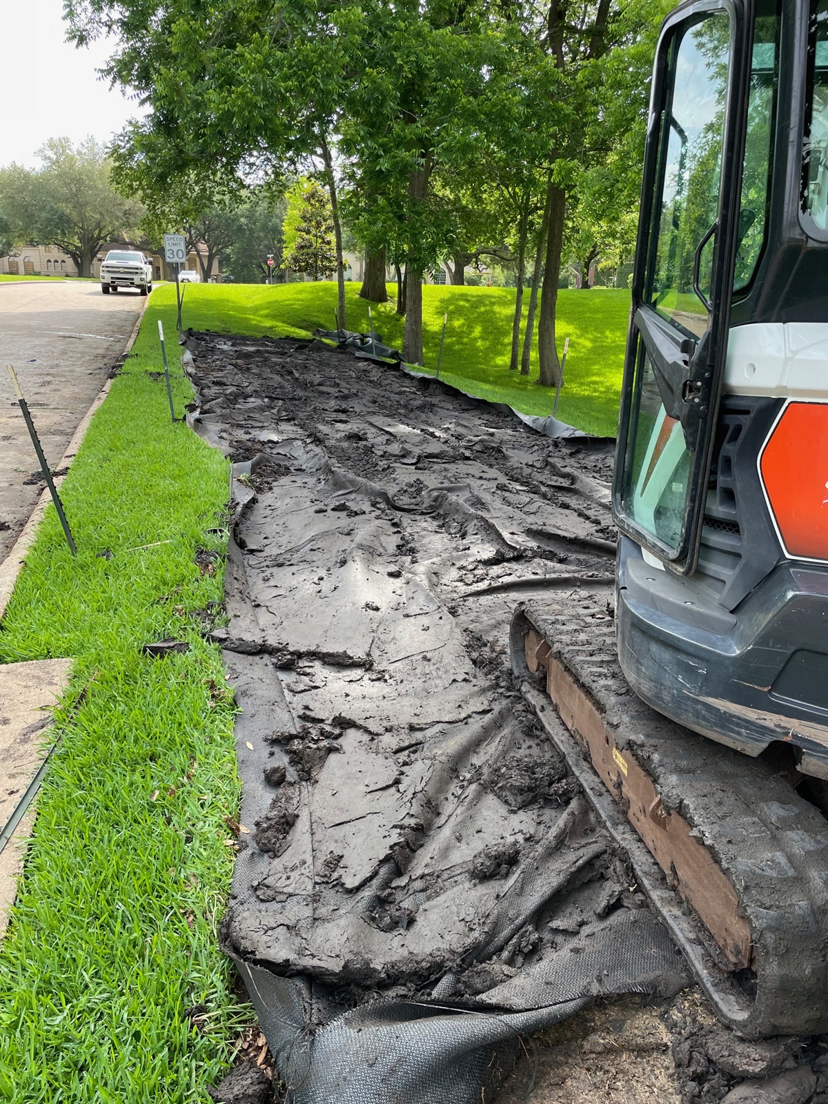 Dewatering bag removal in a residental area after a water retention pond project.
